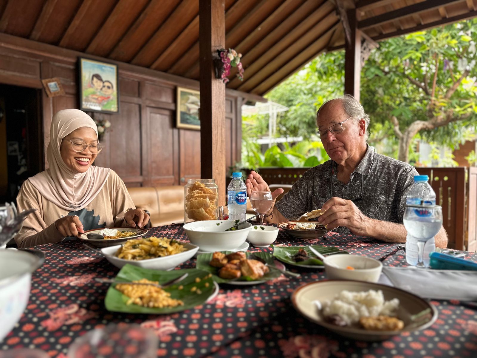 A family gathered around a table for a slow brunch, including an infant and older adults.