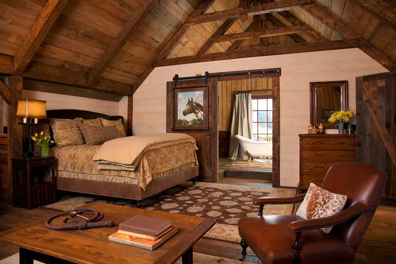 A luxurious loft interior with high ceilings and sophisticated Western furnishings at The Ranch at Rock Creek.