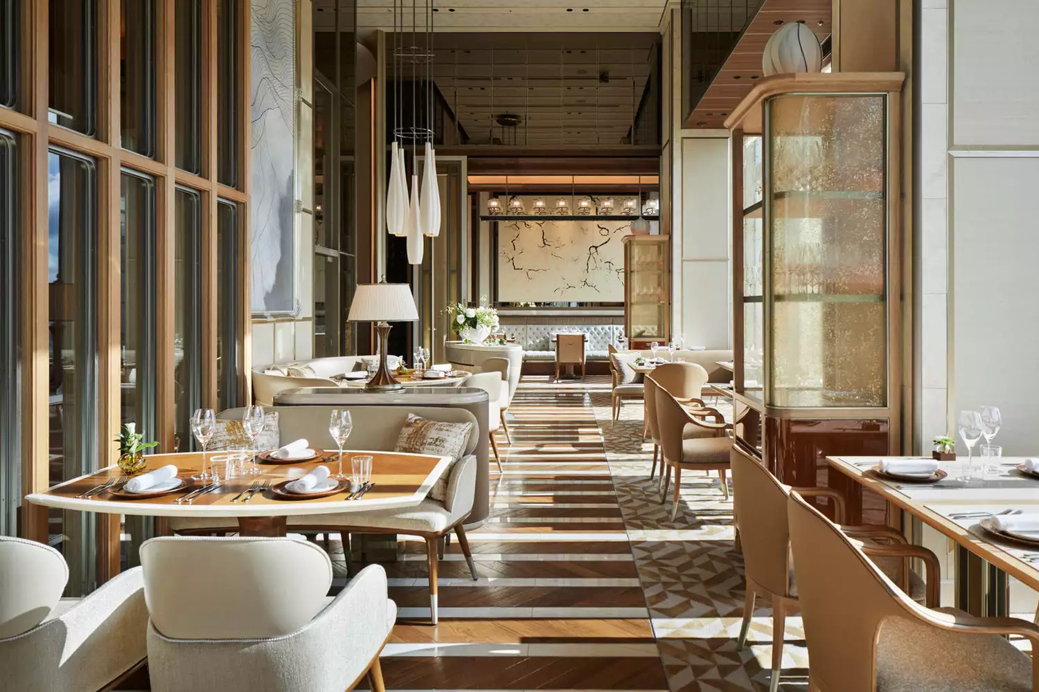 Stylish dining room setup with elegant table settings and city views at a Four Seasons Tokyo restaurant.