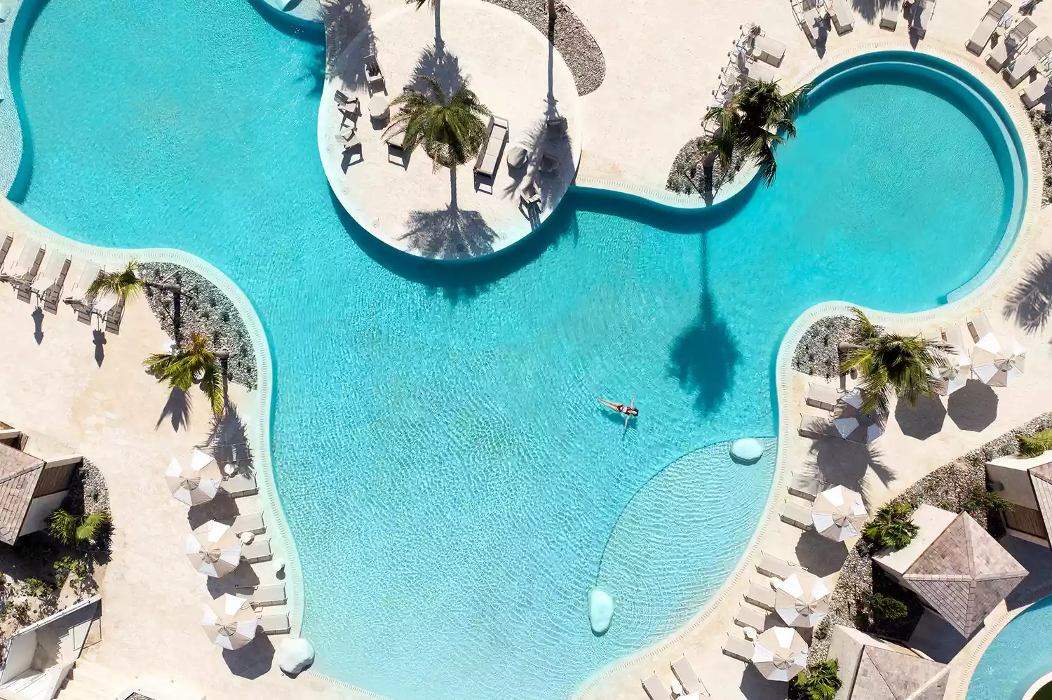 A resort guest enjoying the pool area under the Caribbean sun.
