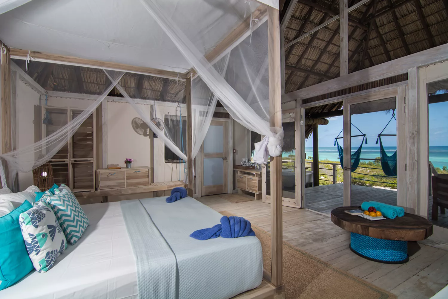 Interior of a luxury hotel room at Anegada Beach Club with a view of the ocean.