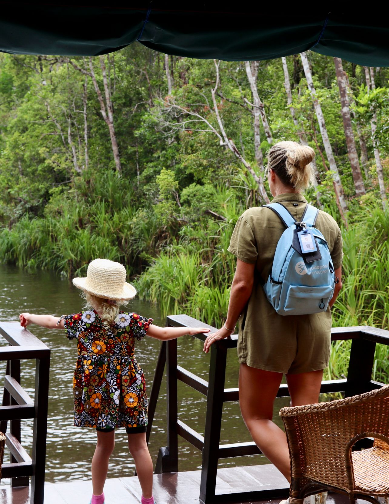 A traveler with a backpack walking through a dense rainforest environment.