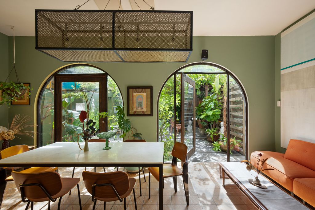 Bohemian interior of the Dreamcatcher hotel with white walls, plants, and traditional tile floors.