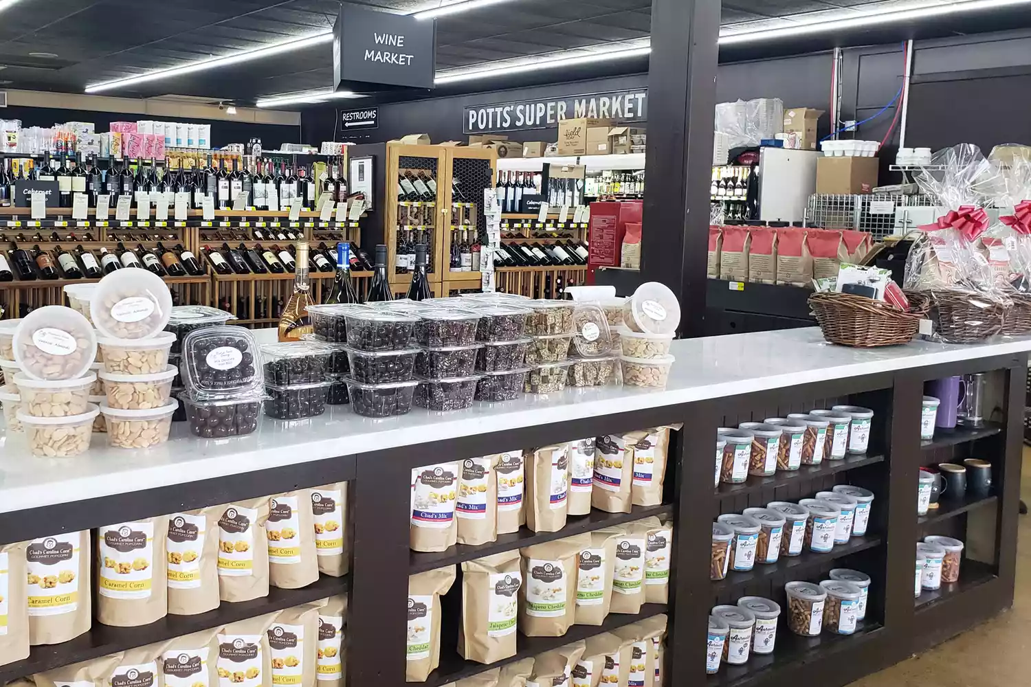 Gourmet food and wine selections displayed inside Mountain Fresh Grocery in Highlands.