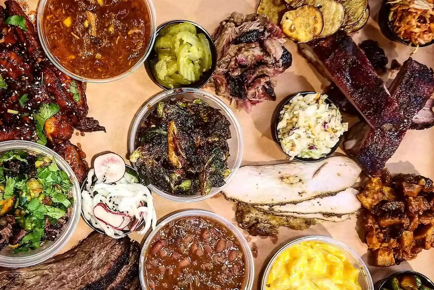 A variety of BBQ meats and sides served on a tray at Heirloom Market BBQ.