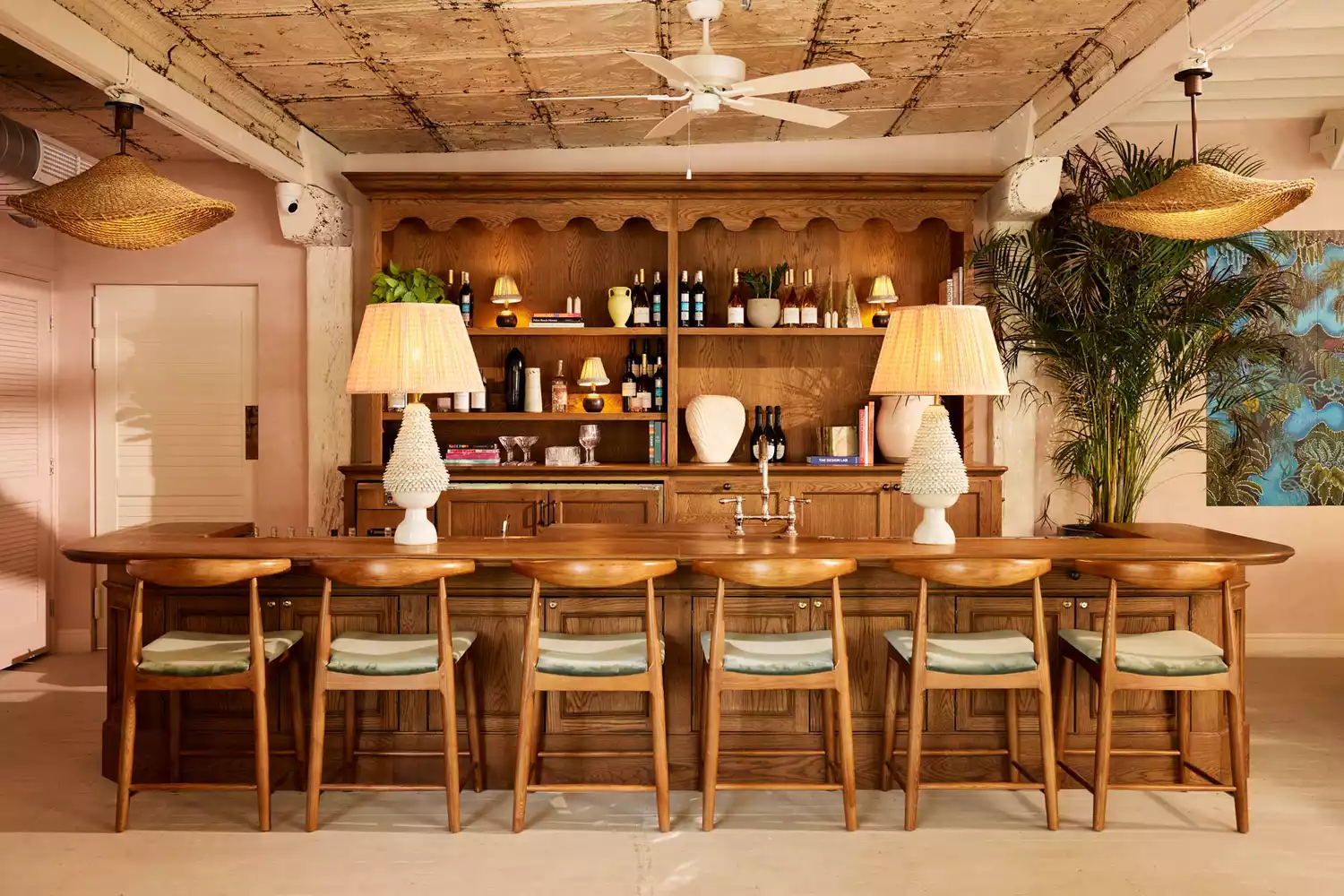 The main bar at Miami Pool House featuring industrial-chic design and mid-century modern furniture.