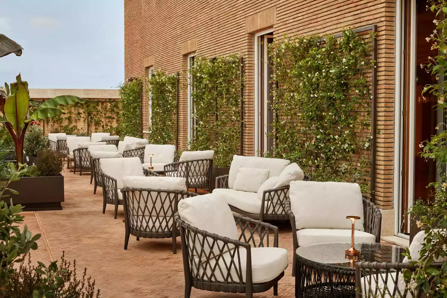 Outdoor terrace bar at Bulgari Hotel Roma with comfortable lounge seating.