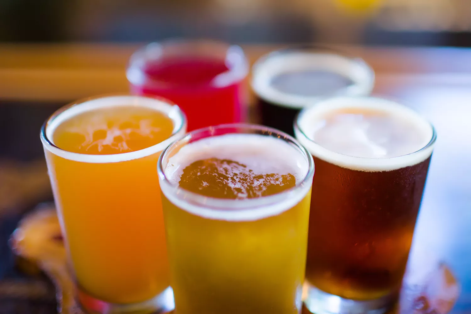 A variety of craft beer tasters arranged on a table at Innovation Brewing in Sylva.