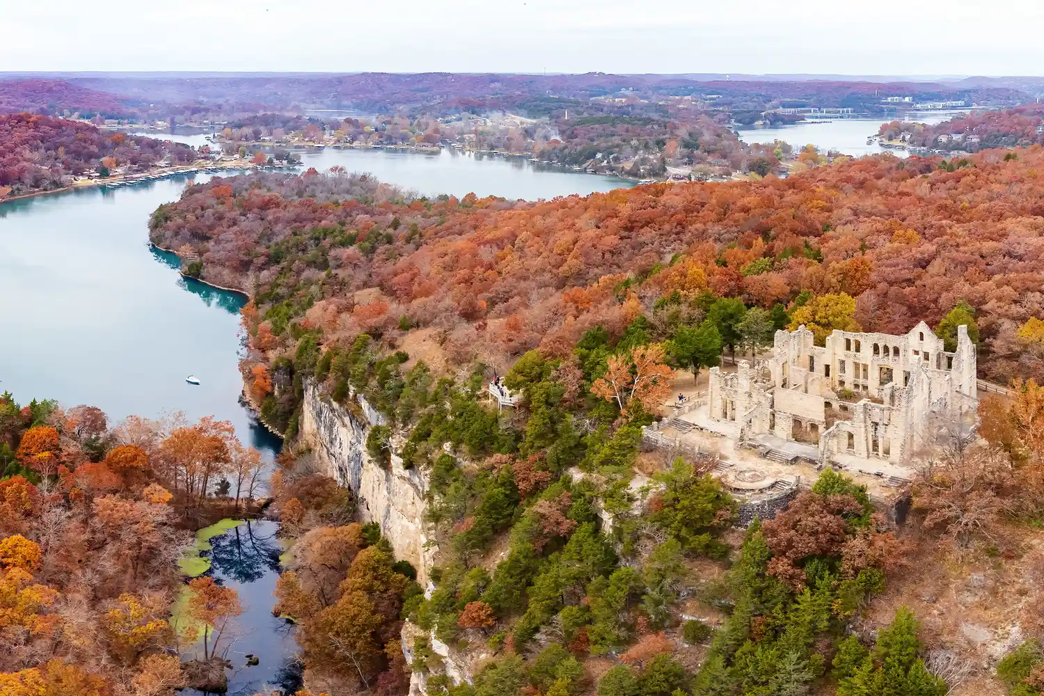 Aerial shot of the Lake of the Ozarks in Missouri, displaying vibrant fall leaf colors across the hills.