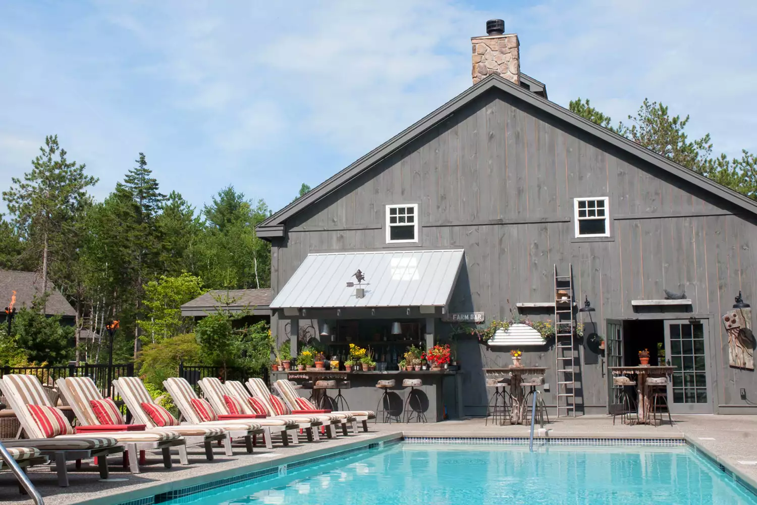 The Serenity Pool area at Hidden Pond featuring the farm bar and lounge seating.