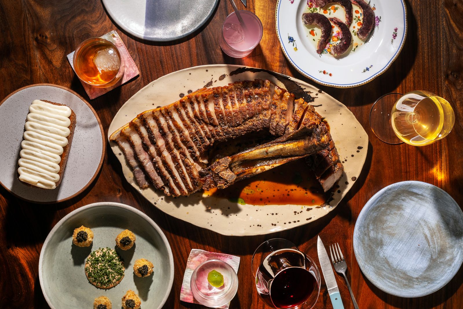A precisely plated meat dish served on a minimalist white plate.