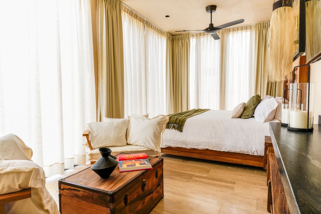 Interior view of a luxury villa at Trobbu Luxury Villas showing refined wood finishes and contemporary Mexican design.