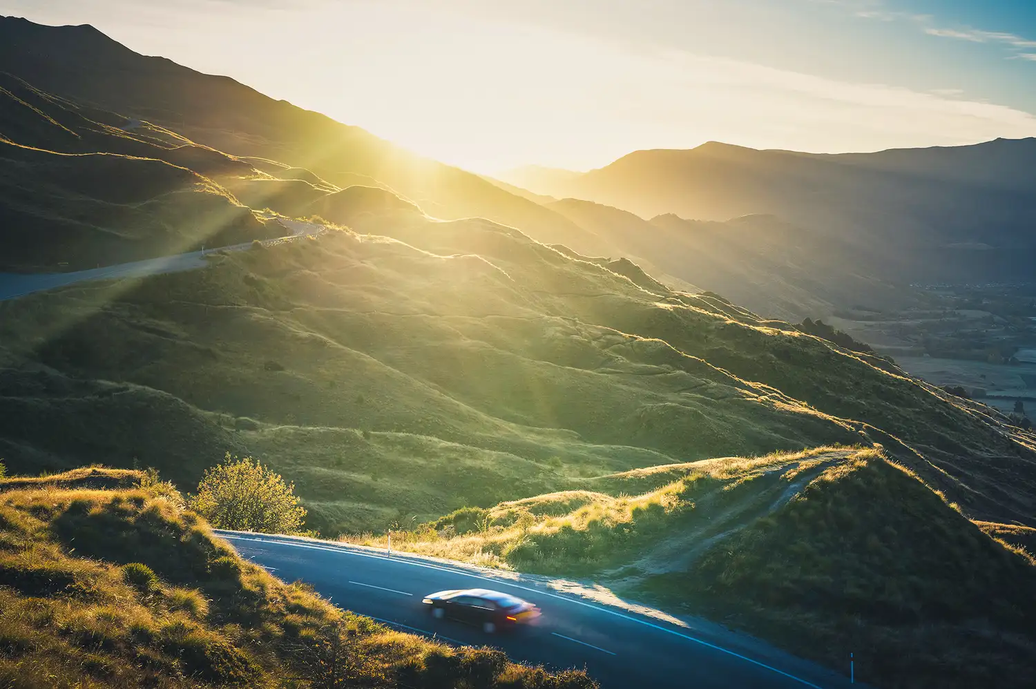 Sunrise view of a narrow winding mountain road at Skippers Road near Queenstown