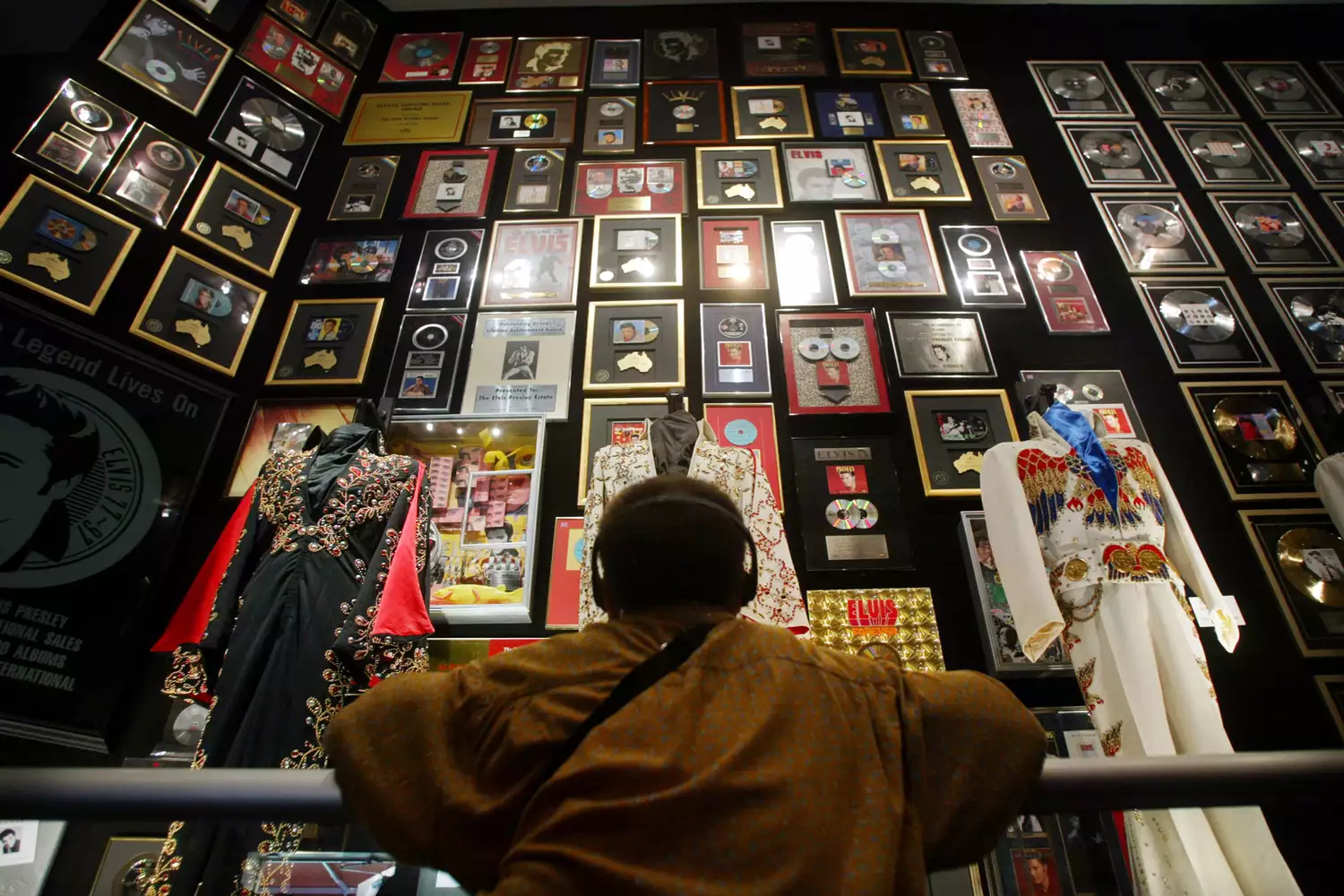 An Elvis fan exploring memorabilia inside the racquetball building at Graceland.