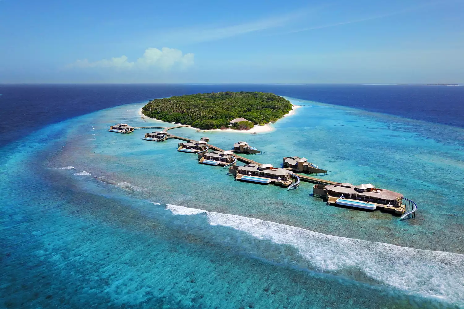 Aerial perspective of luxury villas and dense tropical vegetation at Soneva Fushi.