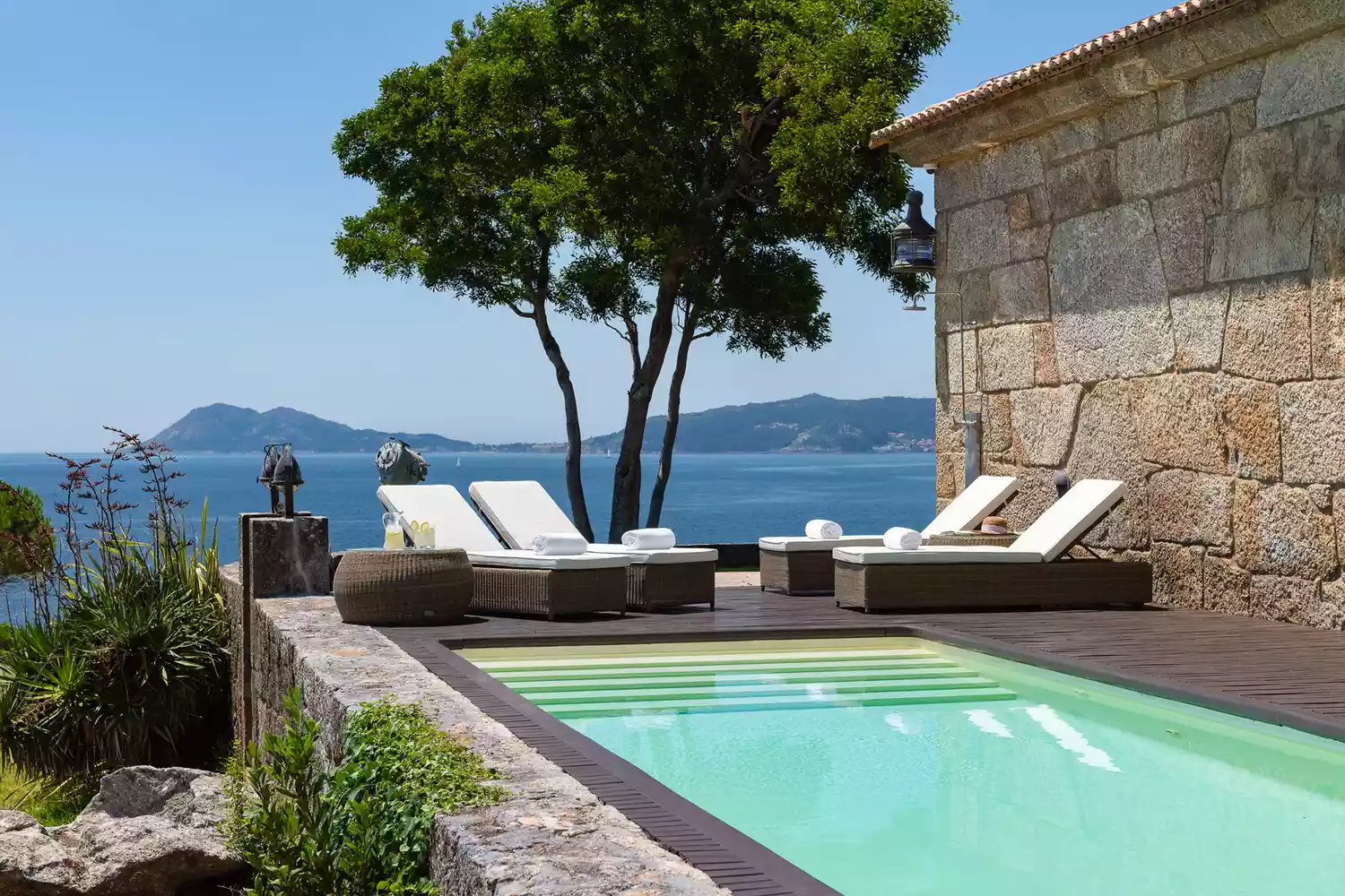 The sleek outdoor swimming pool at A Creba Private Island under a clear sky.