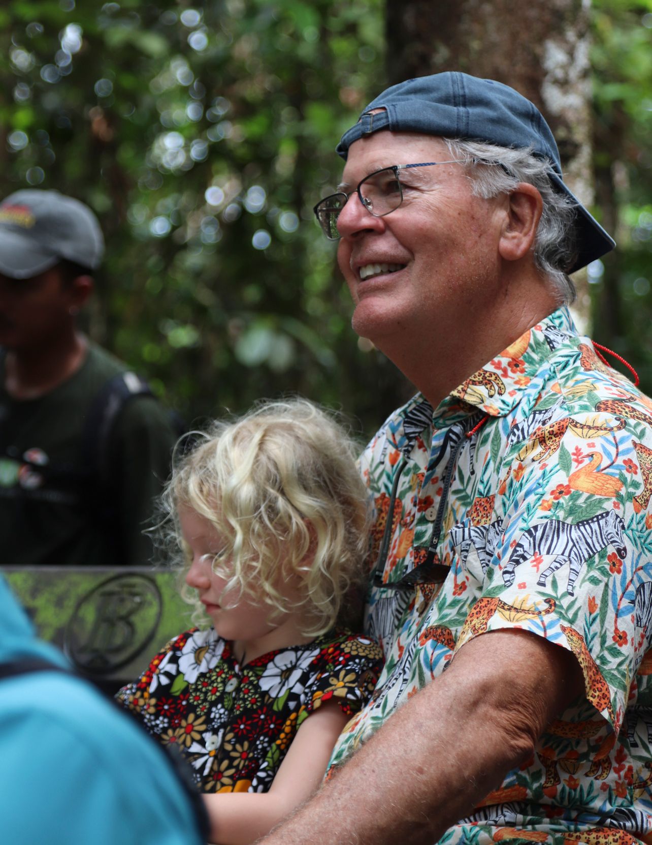 A happy child and adult smiling during a relaxed travel moment.