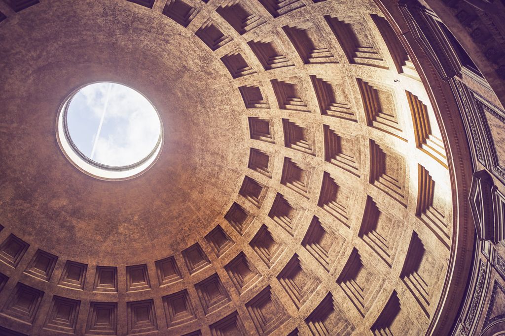Architecture of the Colosseum amphitheater under a clear sky.