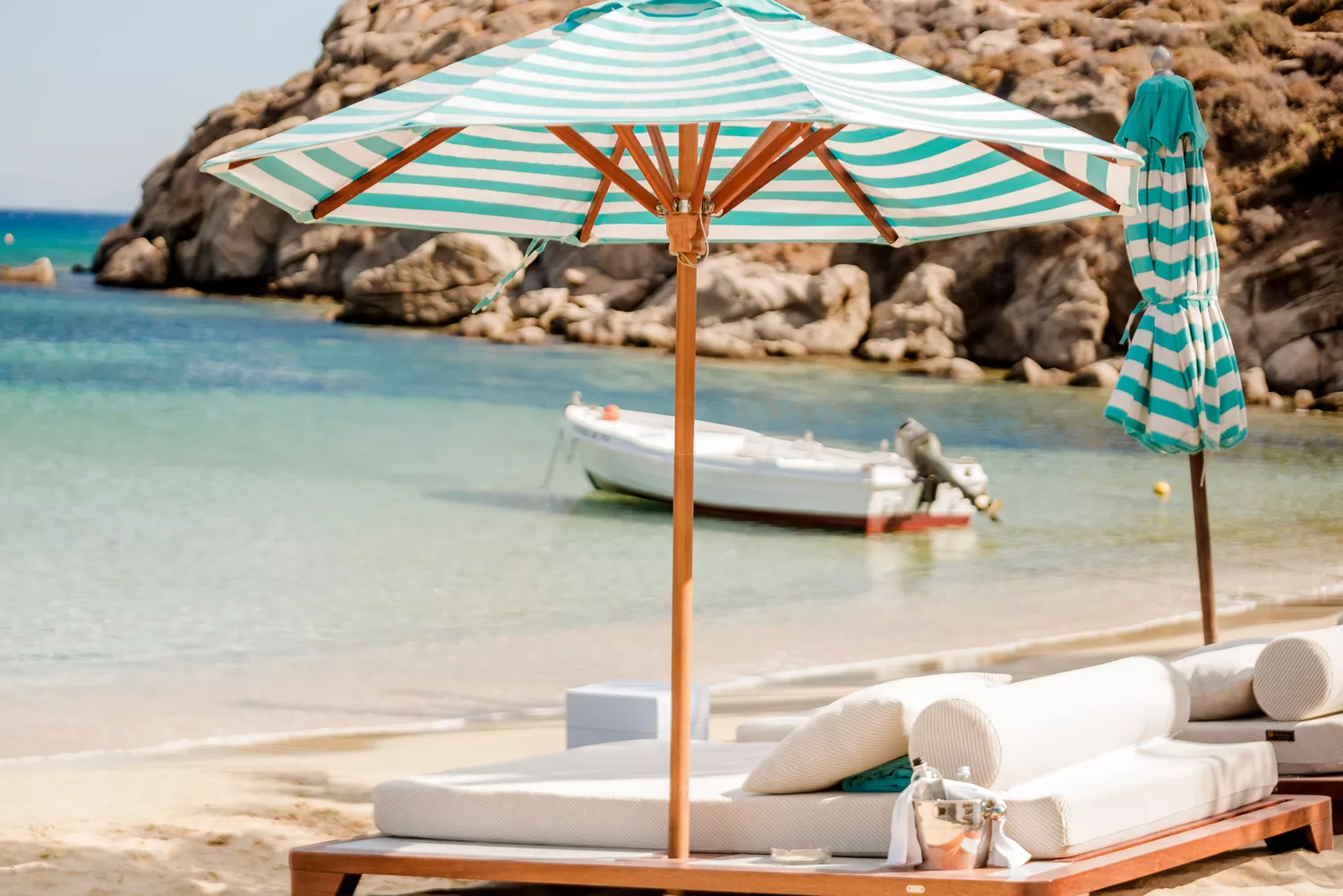 Sunbeds and umbrellas on the exclusive beach at Nammos Hotel Mykonos.