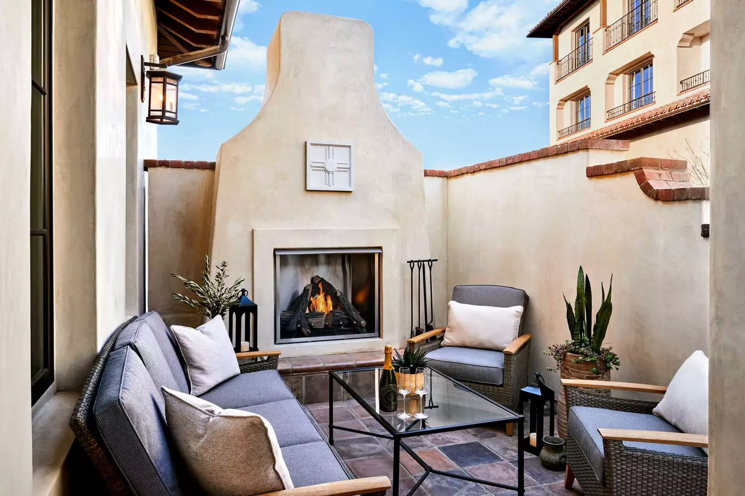 A cozy outdoor fireplace and luxury lounge seating at the Inn at the Mission.