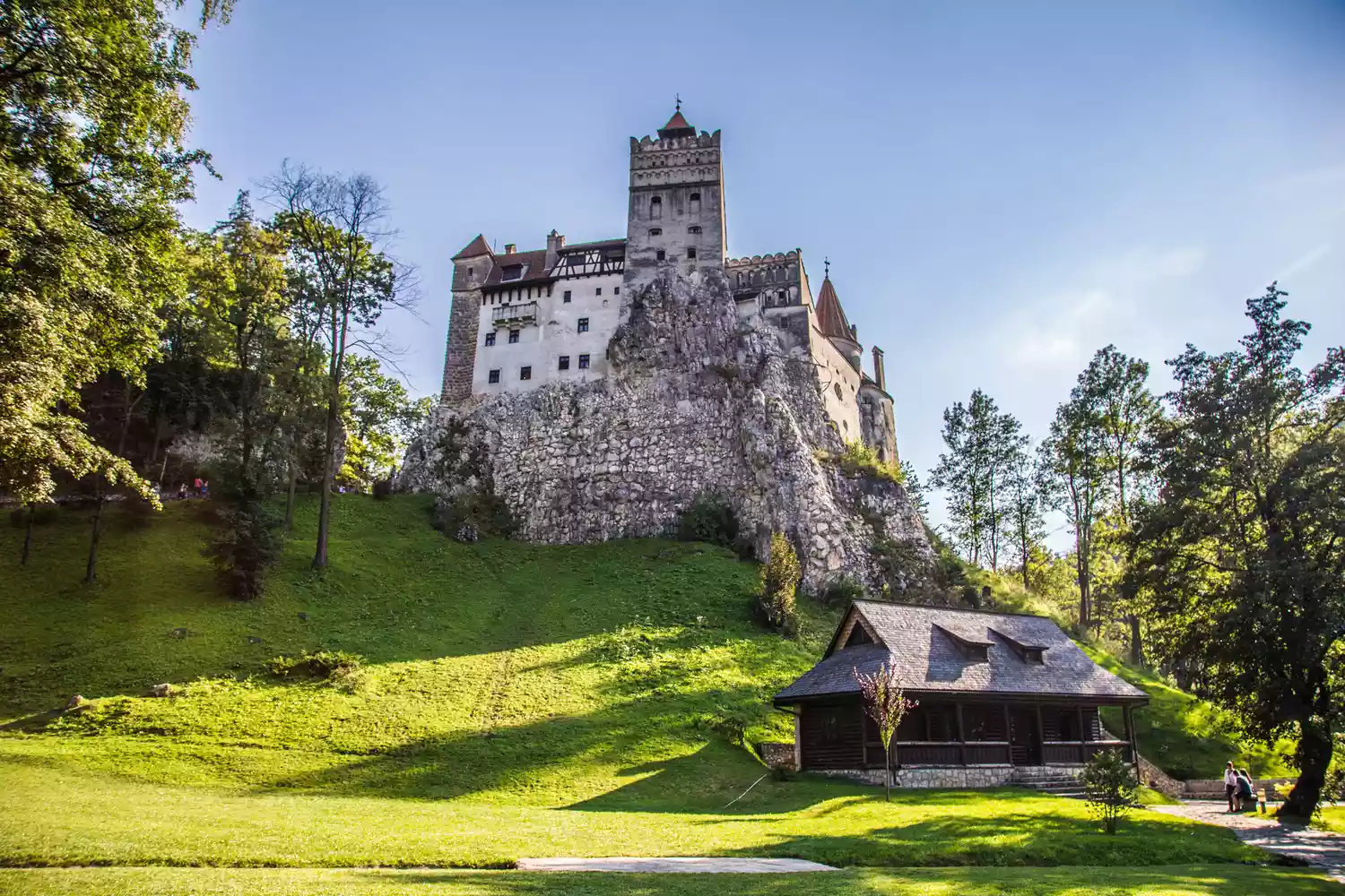 A moody view of Bran Castle's towers in the Transylvanian countryside.