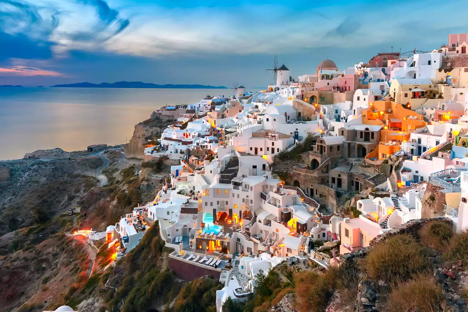 High-angle view of the picturesque old town of Oia showing the dense white Cycladic architecture against the sea.
