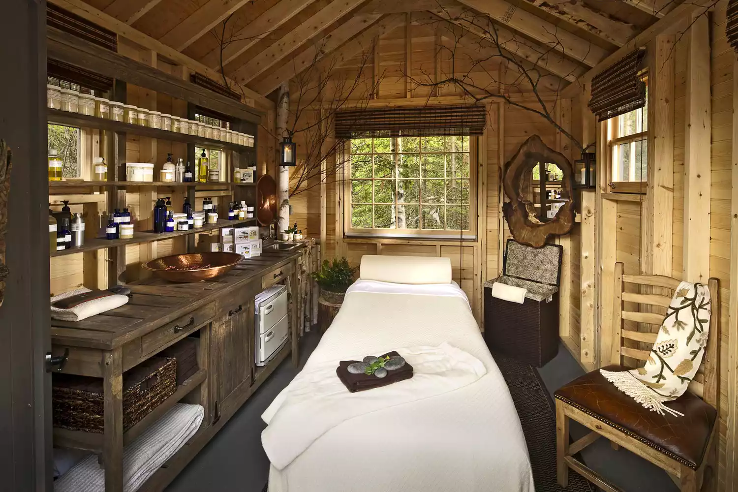 The tranquil interior of a Tree Spa treatment room elevated among the trees.
