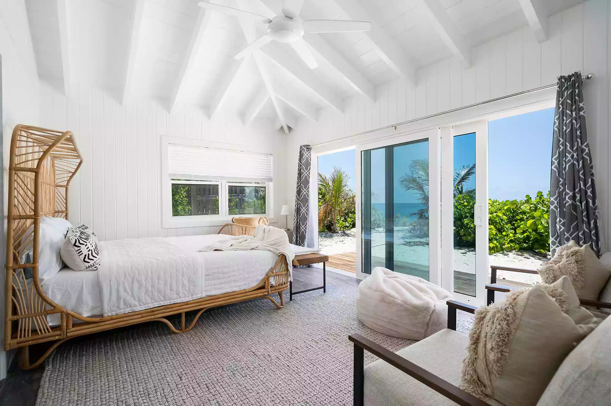 Elegant white bedroom suite in a cottage at The Island Retreat with natural light.