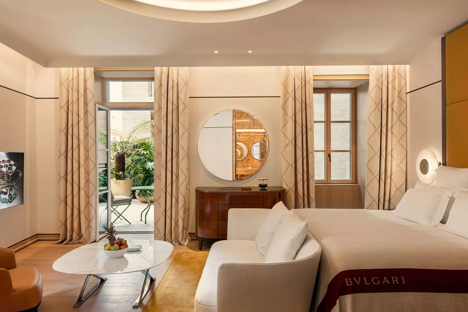 A luxury bedroom at Bulgari Hotel Roma featuring a private terrace and contemporary Italian furniture.