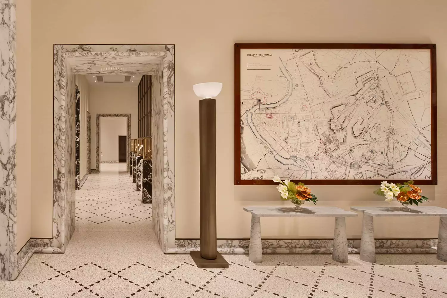 Reception concierge area and a long marble hallway inside Bulgari Hotel Roma.