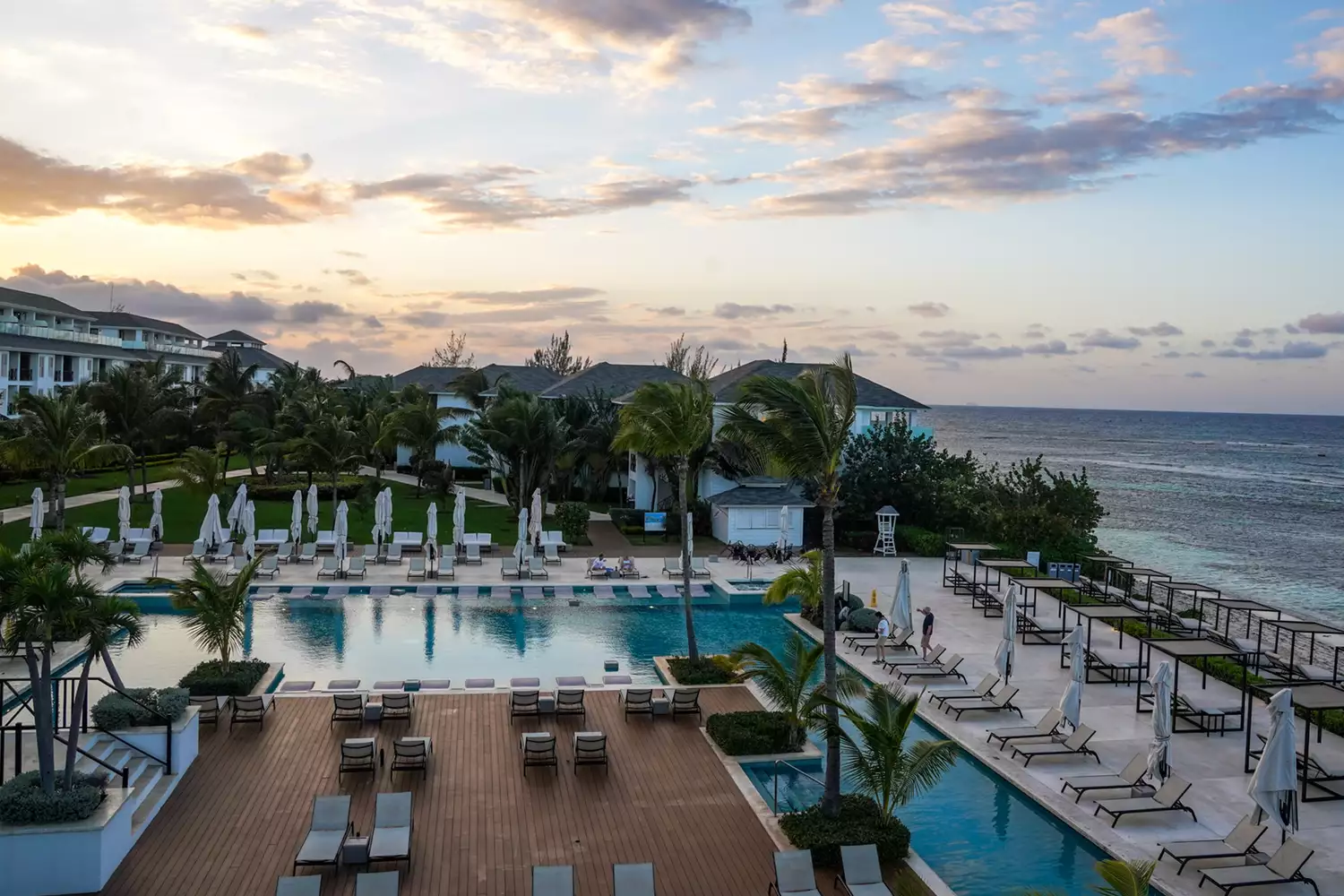 Aerial view of Excellence Oyster Bay resort situated on a private peninsula surrounded by turquoise water.