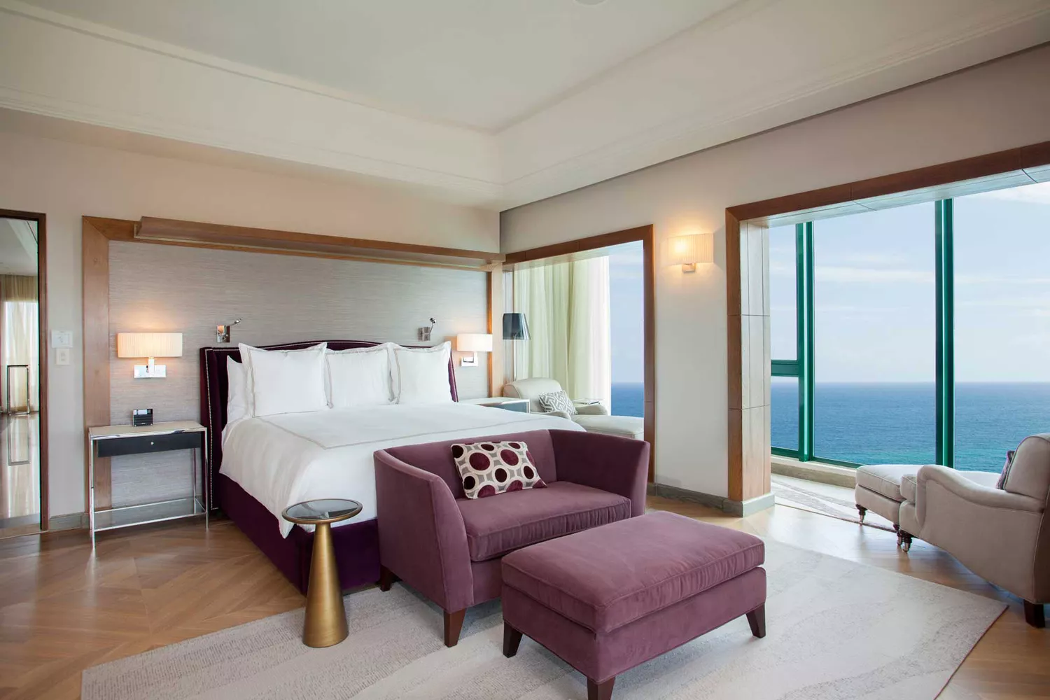 The Vanderbilt Suite Master Bedroom at Condado Vanderbilt Hotel showing an elegant bed and ocean-view window.