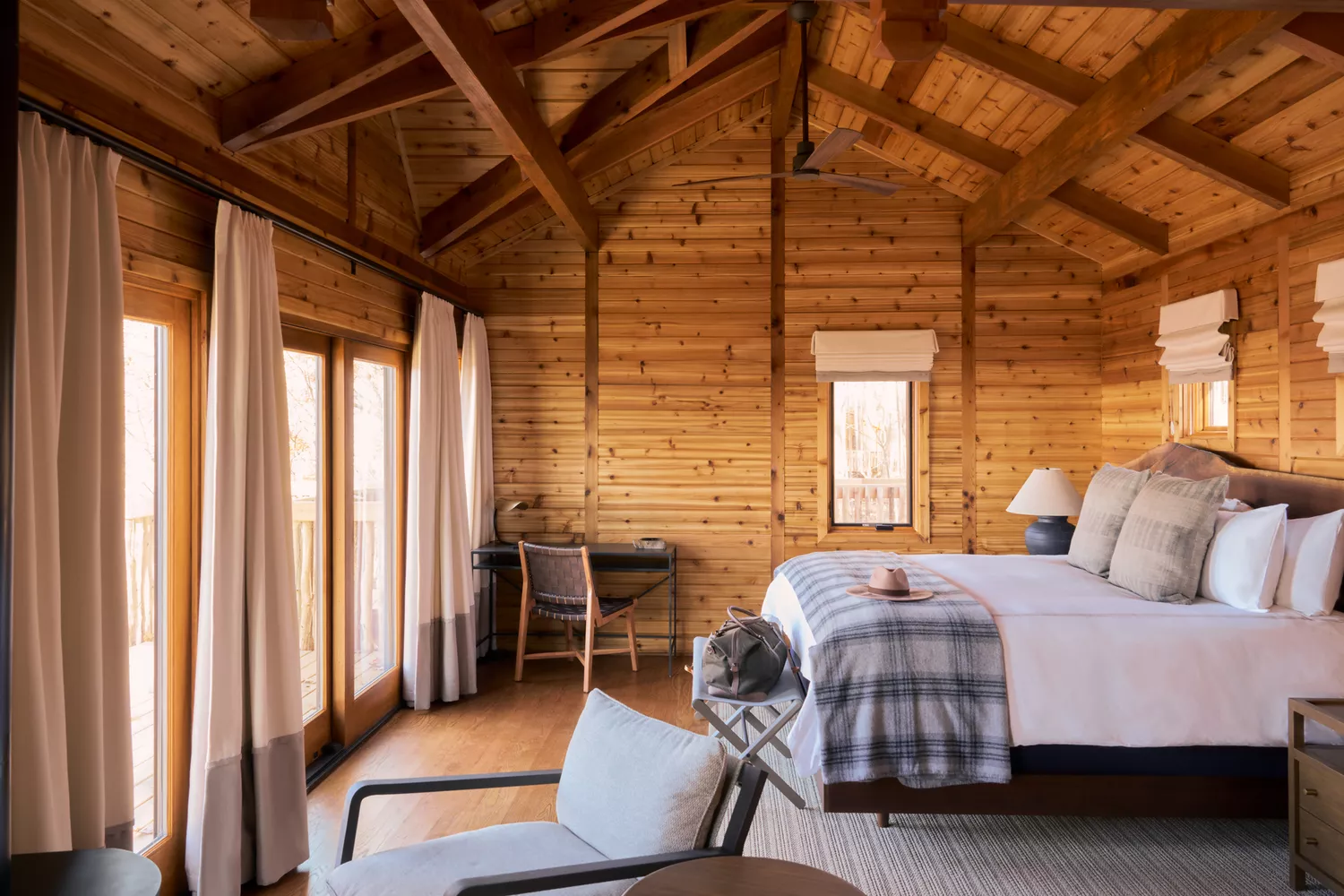 The contemporary interior of a Primland treehouse suite featuring warm wood accents and modern furniture.