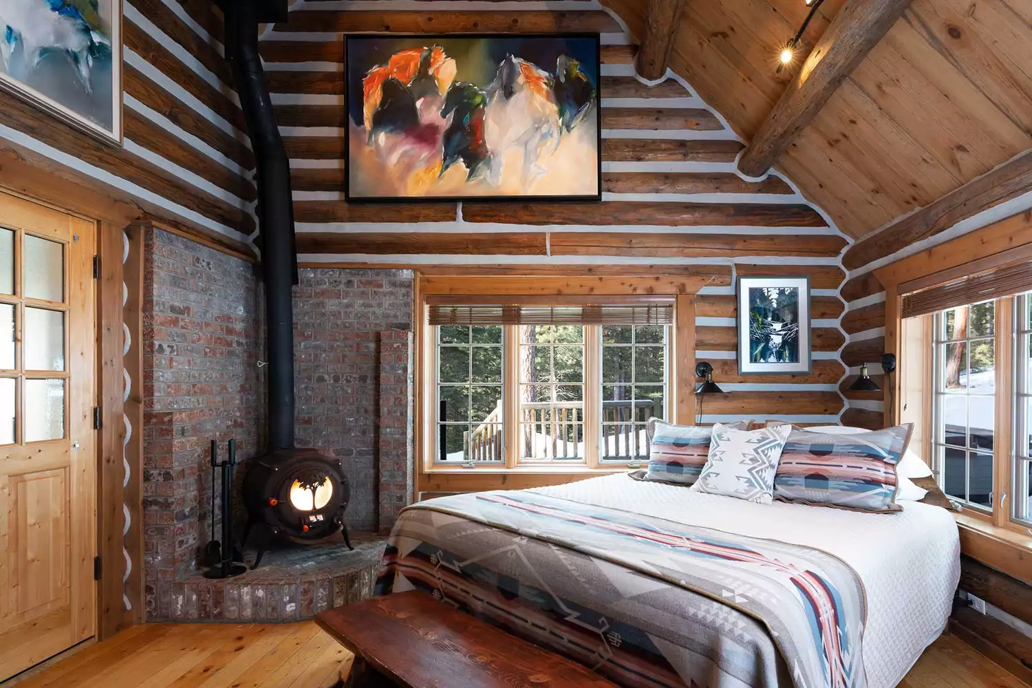Cozy cabin interior at Triple Creek Ranch featuring log walls and refined Western decor.