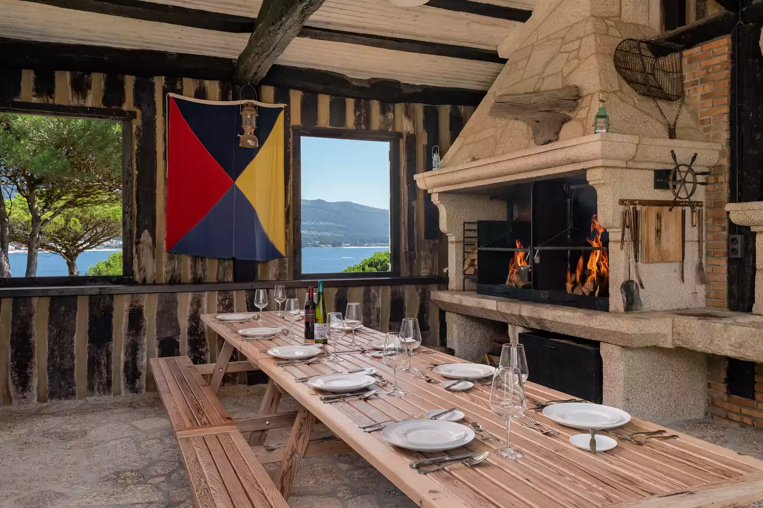 The outdoor BBQ and dining terrace at A Creba Private Island set for a meal.