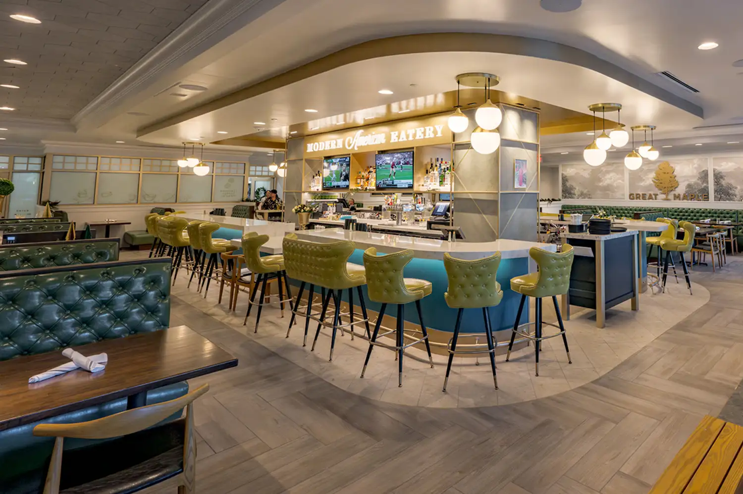 The interior of Great Maple restaurant at Pixar Place Hotel with modern bar seating and a sophisticated atmosphere.