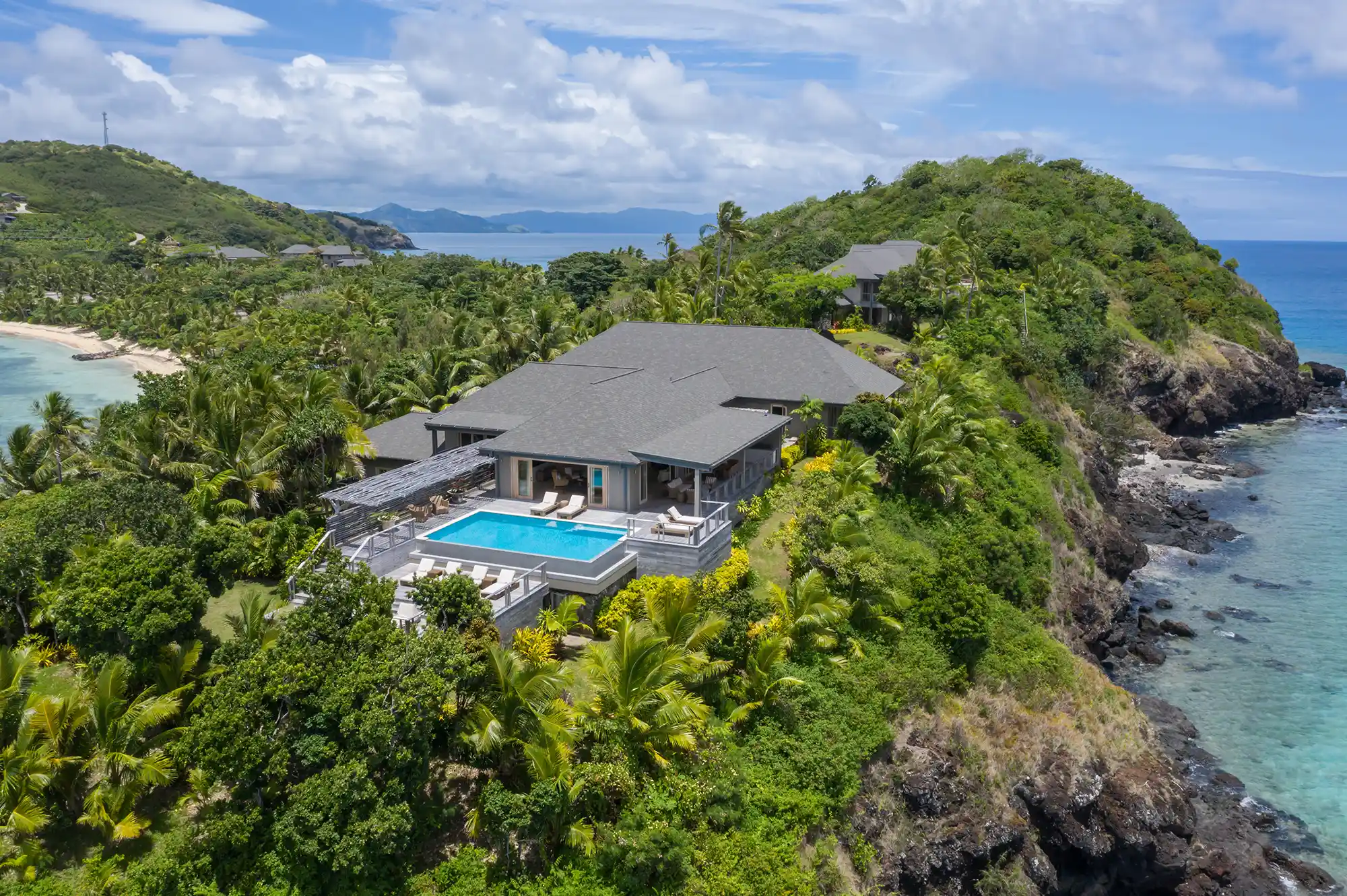 Luxury villa on a tropical cliffside with a private infinity pool overlooking the Pacific Ocean.