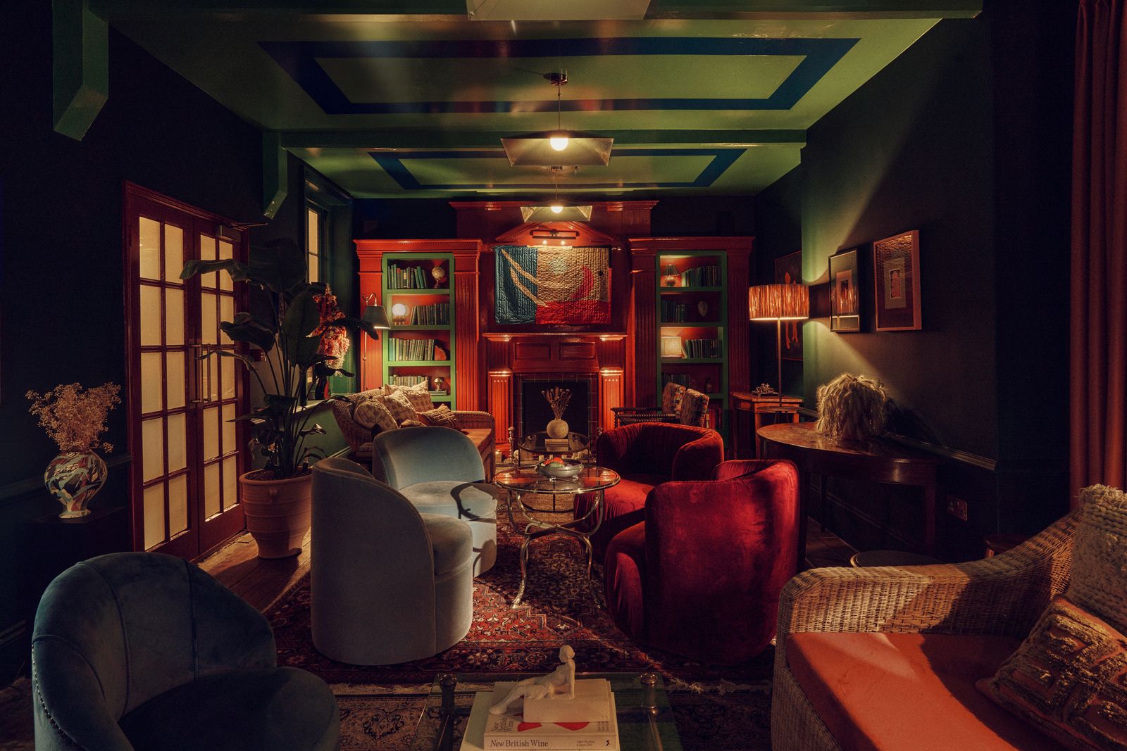 A luxury living room within a Georgian manor featuring a fireplace and bespoke artisanal furniture.