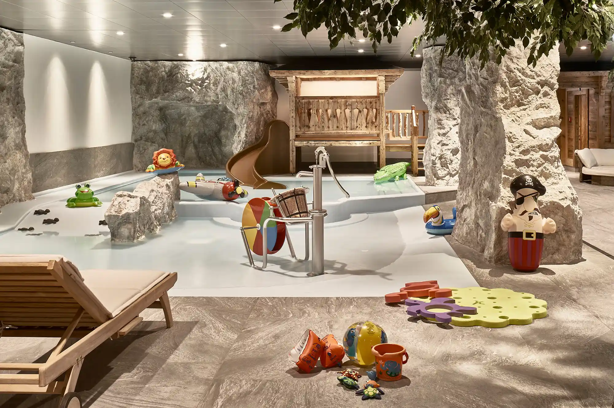 An bright indoor water play area for children with shallow pools and colorful slides.