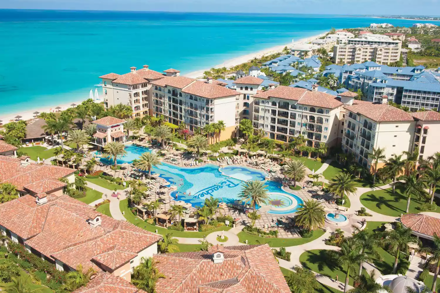 Wide-angle aerial shot of Beaches Turks and Caicos resort showing the beachfront and extensive pool complexes.