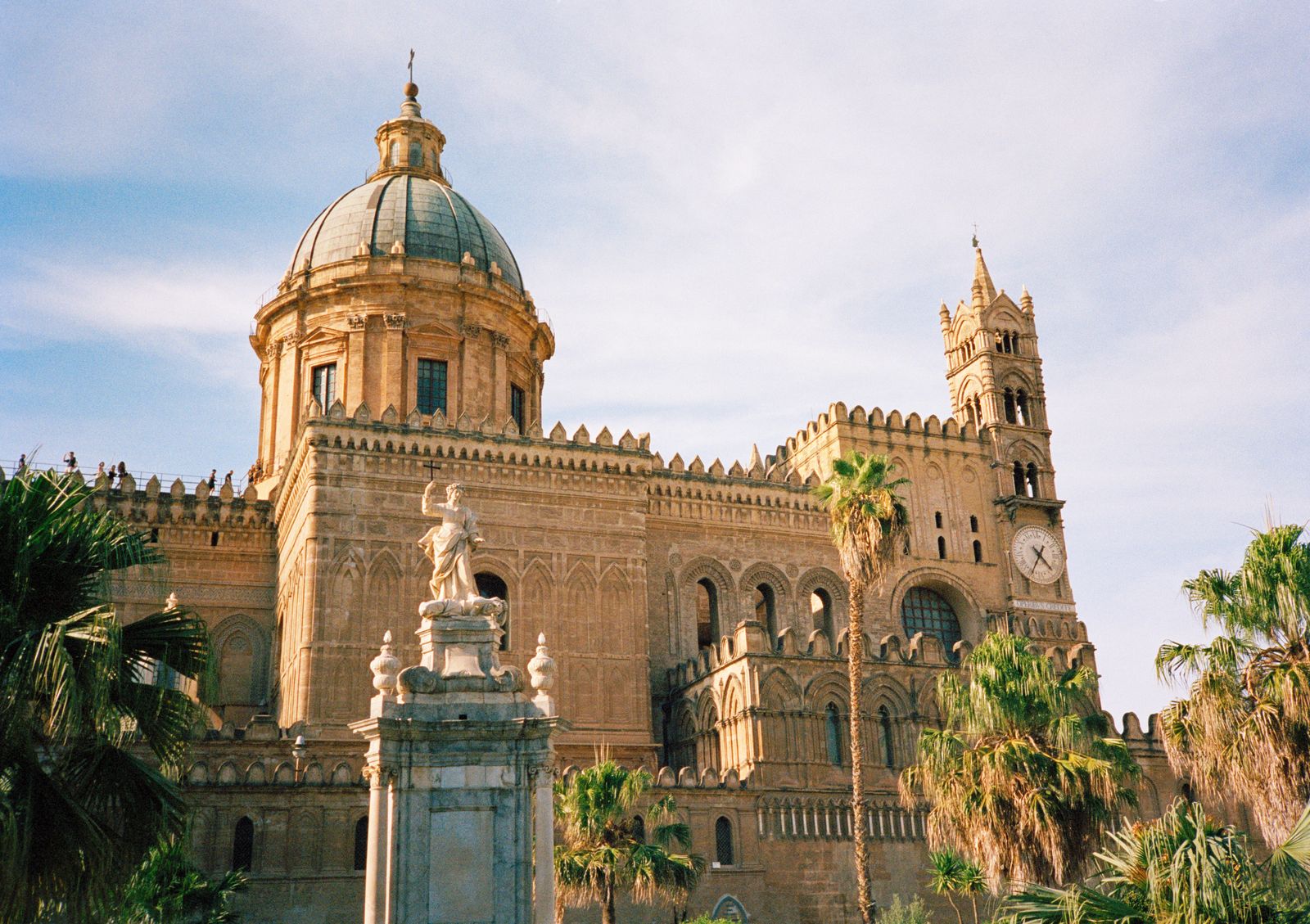 An architectural view of a historic Italian church dome with a person in wedding attire.