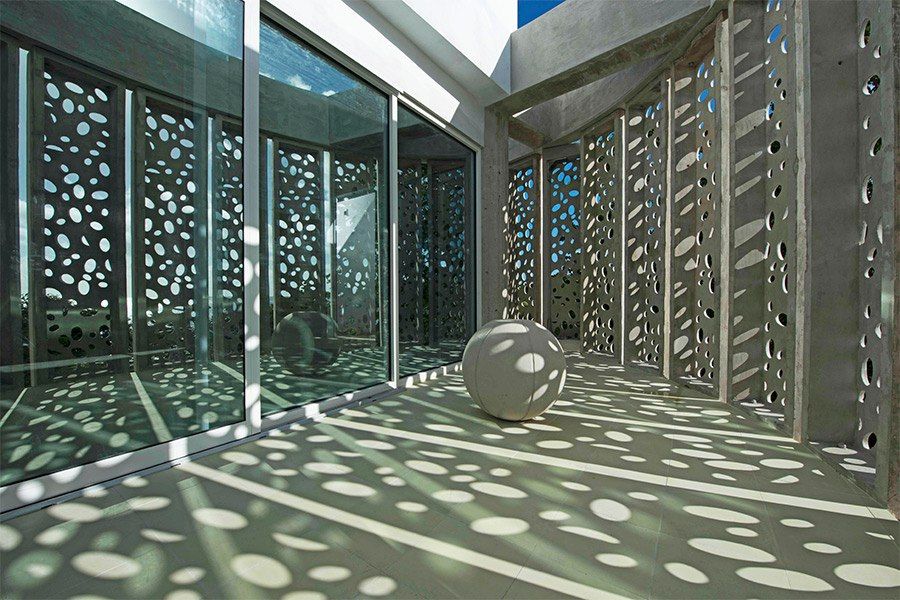 Modern, perforated gray concrete exterior of El Blok hotel in Vieques.