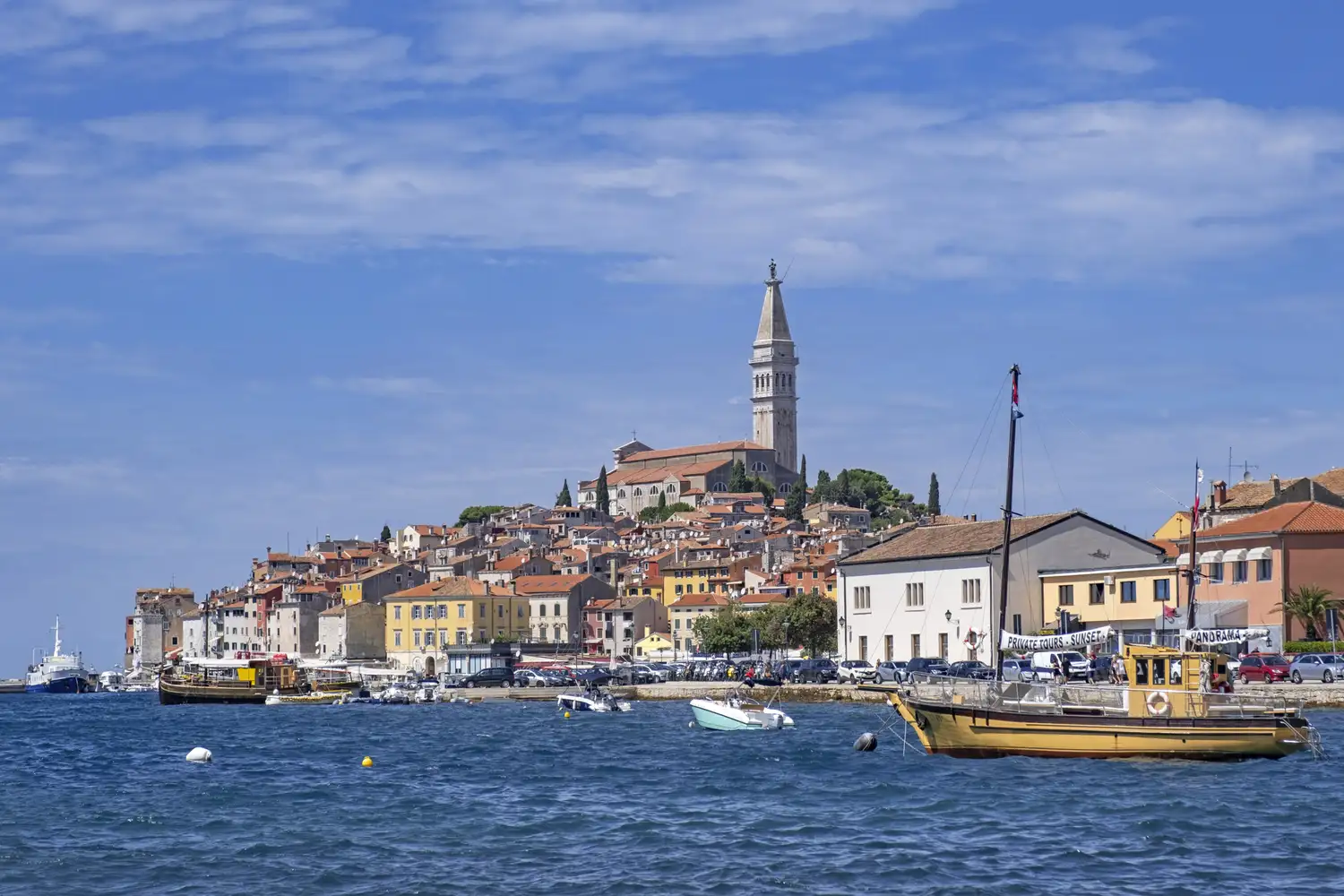 The Church of St. Euphemia overlooking the colorful harbor and seaside buildings of Rovinj, Croatia.