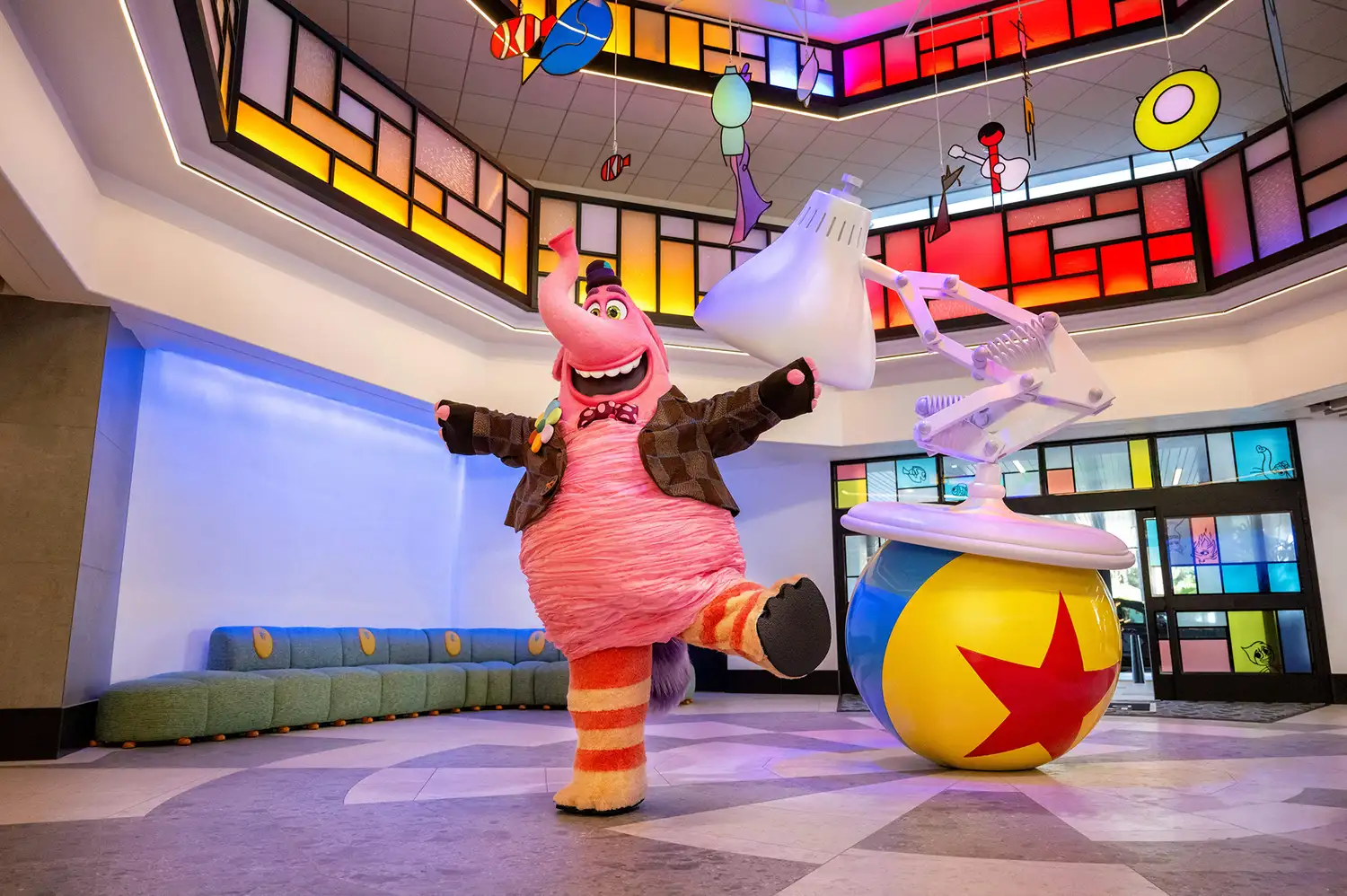 The lobby of Pixar Place Hotel featuring the Luxo Jr. lamp, Pixar ball, and a Bing Bong statue.