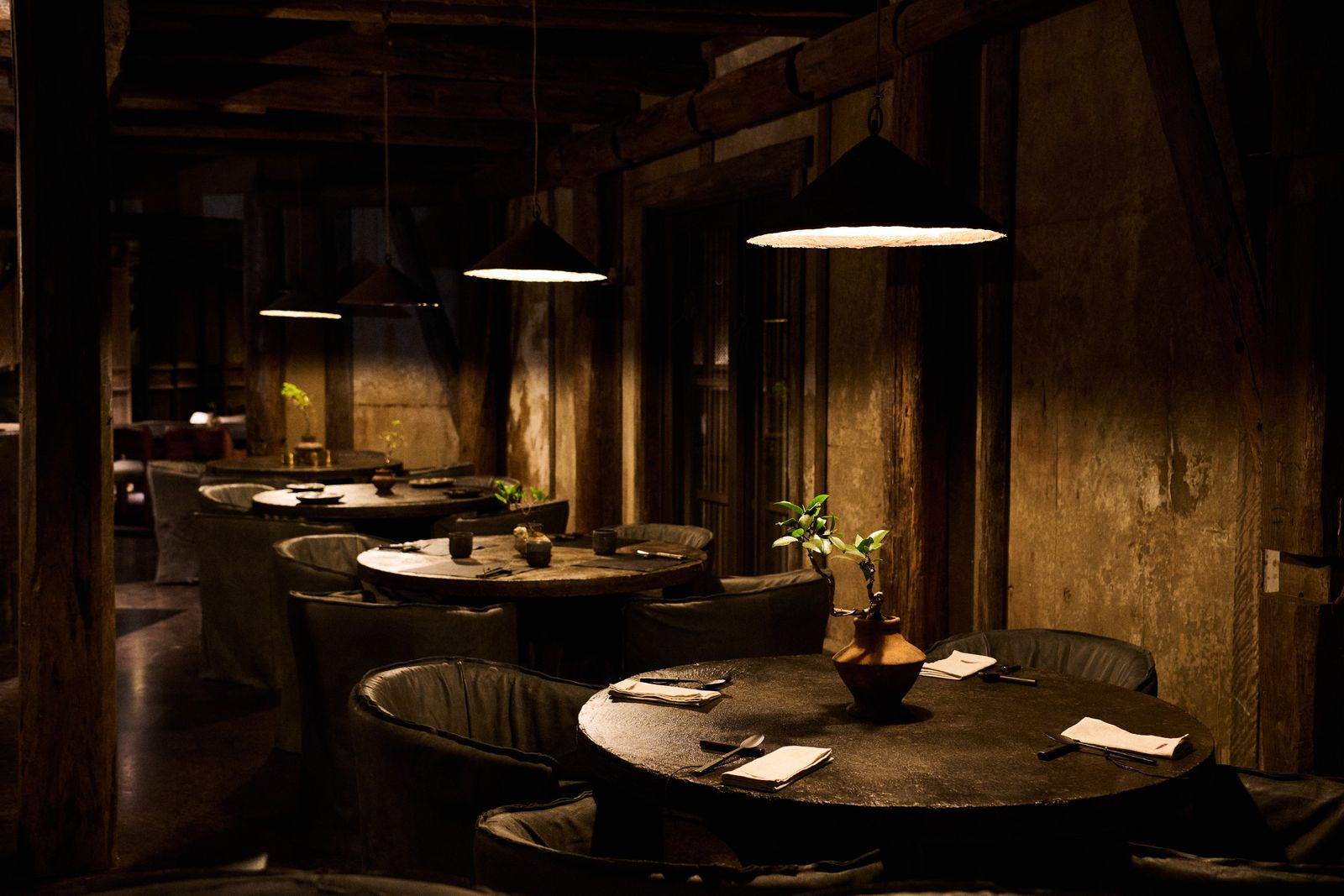 An elegant restaurant dining room featuring Art Deco design elements and warm lighting.