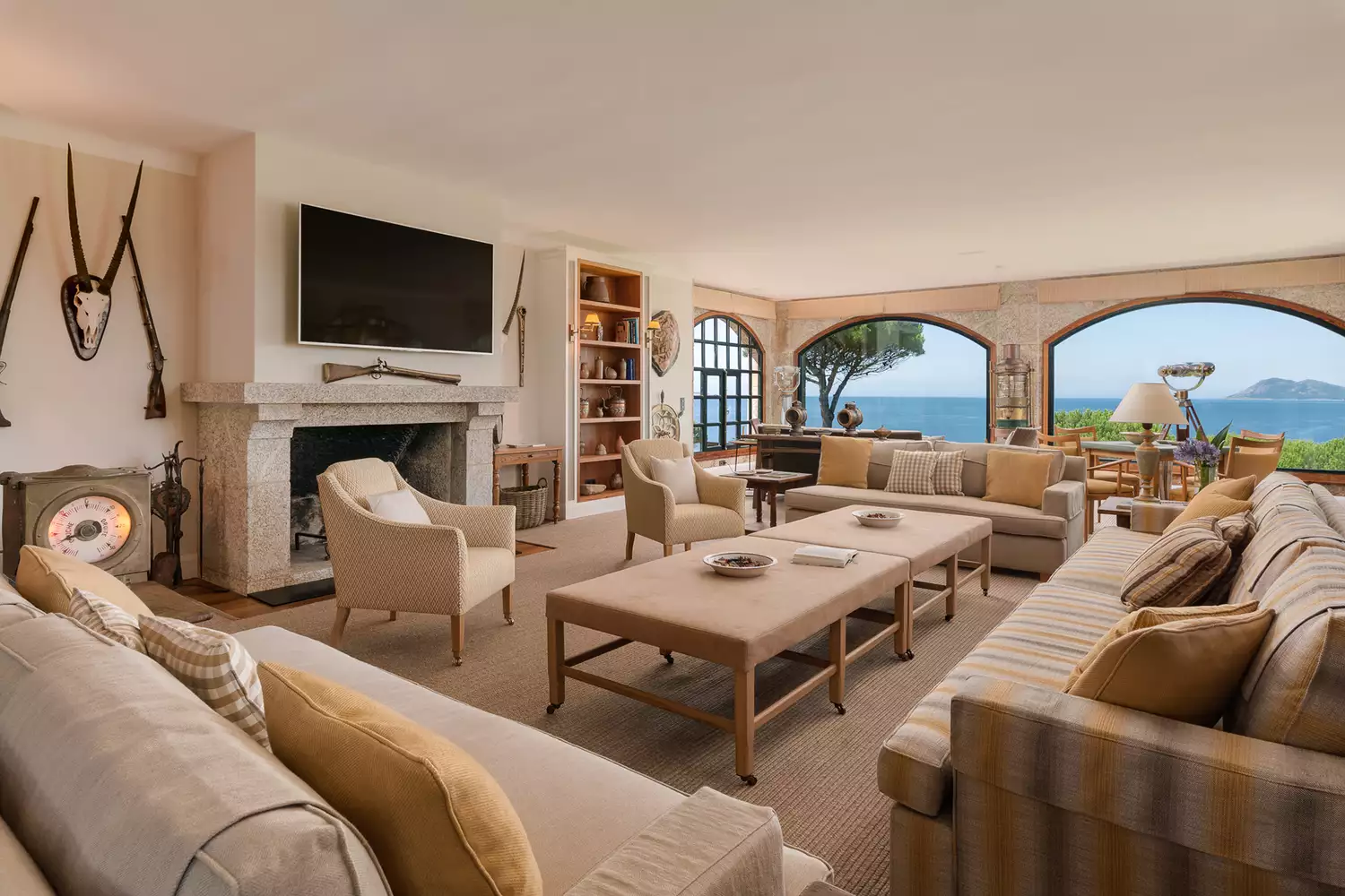 The contemporary living room of the A Creba villa with large windows overlooking the ocean.