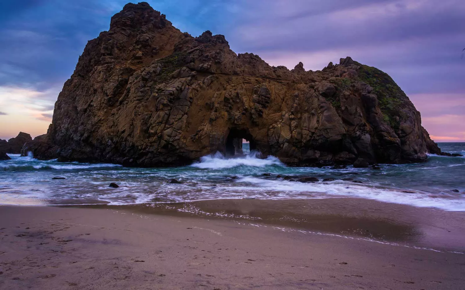 The purple and pink tinted sands of Pfeiffer Beach in Big Sur, California.