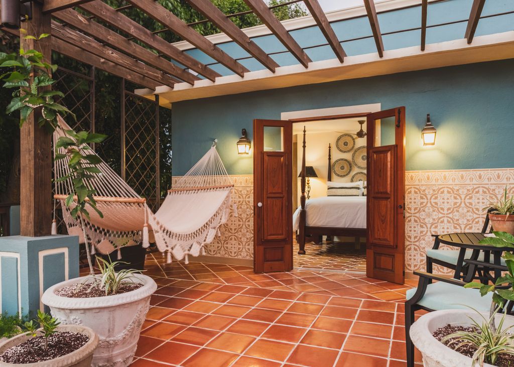 Intimate bedroom interior at Puertas at El Quenepo with Caribbean cottage styling.