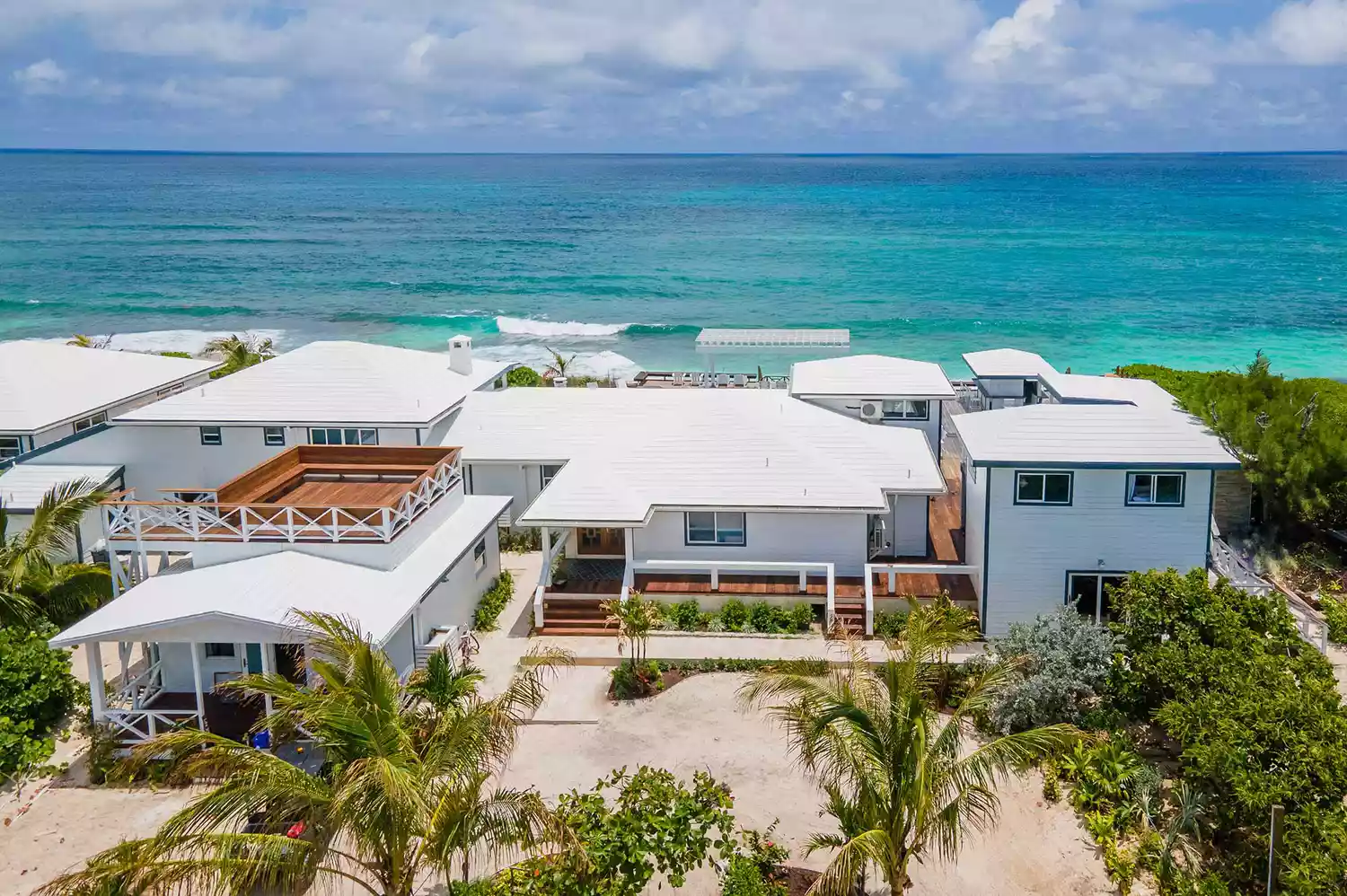 Aerial view of turquoise waters surrounding The Island Retreat boutique hotel and private docks.