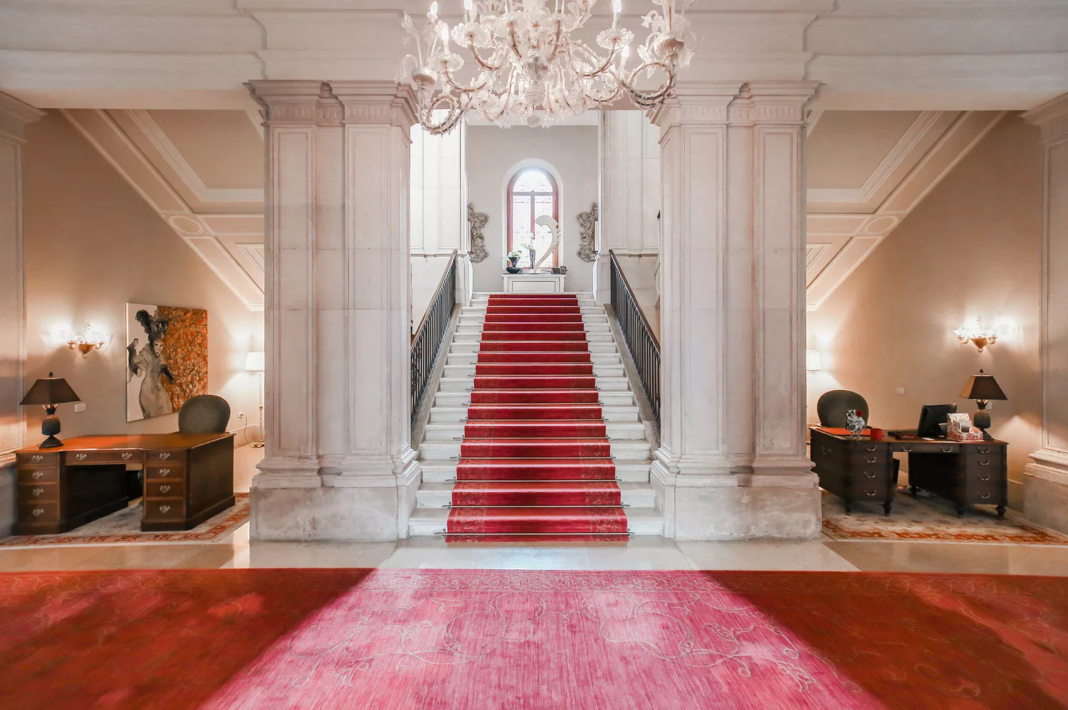 The ornate Imperial Stairs inside the San Clemente Palace Kempinski showing classical Venetian architecture.